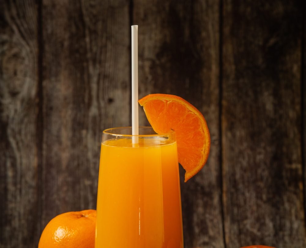 Fresh orange juice in a glass and fresh orange